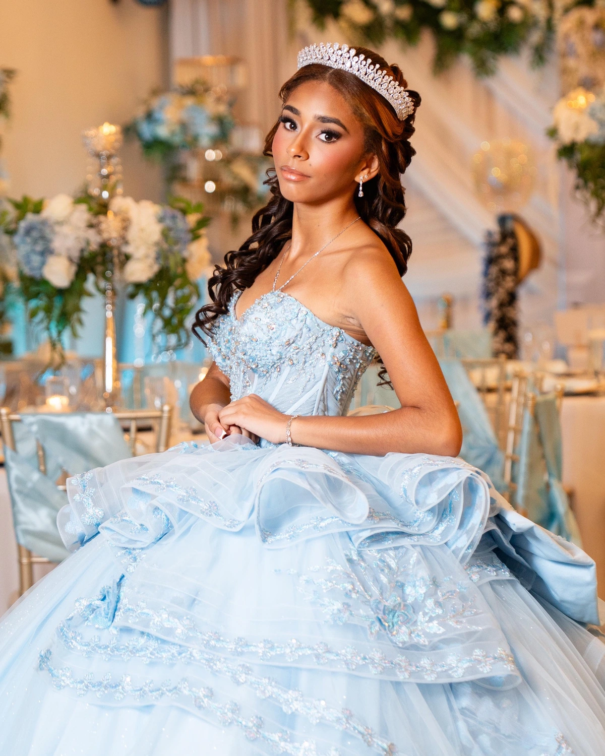 A quinceañera in a blue gown at Nencini Ballroom
